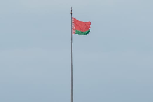 flag of the Republic of Belarus is displayed on the flagpole. Stock photo.