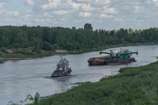 Chernihiv, Ukraine - 07/12/2018: ship and barge on the riverbed. Stock photo.