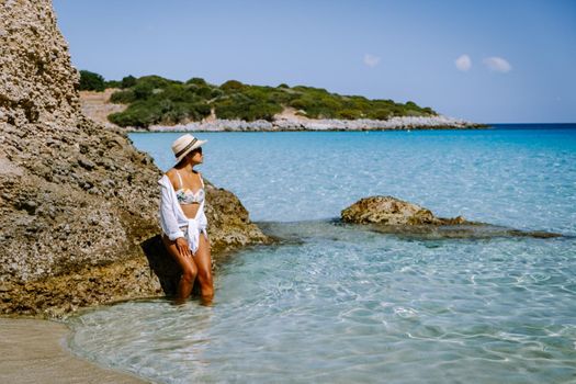 Tropical beach of Voulisma beach, Istron, Crete, Greece Europe, woman mid age asian on the beach