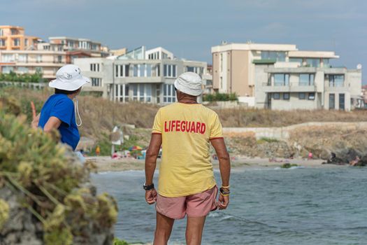Sozopol, Bulgaria - 09/06/2018: a Man in a t-shirt with the inscription lifeguard. Stock photo