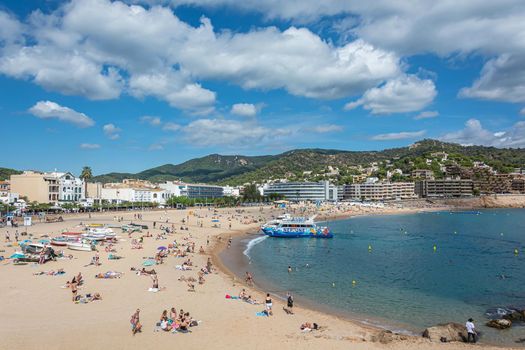 Tossa, Spain - 09/19/2017: city beach and pleasure boat. Stock photo.