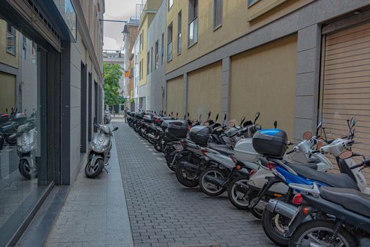 Lloret De Mar, Spain - 09/22/2017: scooter Parking on the city street. Stock photo.