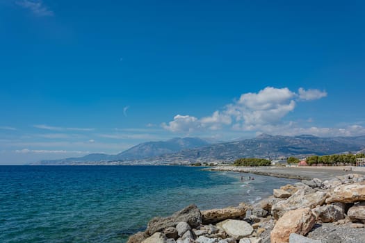 Seascape. Coastline and beach of the resort of Agios Nikolaos (Crete, Greece). Stock photo