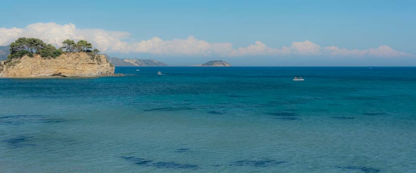 Seascape. An island in the sea and clouds on the horizon. Stock photo