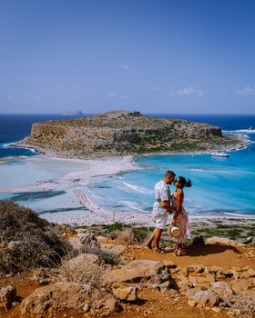 Crete Greece, Balos lagoon on Crete island, Greece. Tourists relax and bath in crystal clear water of Balos beach. Greece, couple men and woman visiting the beach