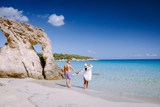 Young happy couple on seashore Crete Greece, men, and woman Voulisma beach Crete Greece. Europe