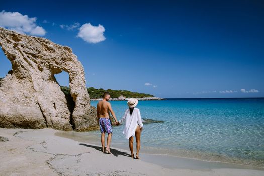 Young happy couple on seashore Crete Greece, men, and woman Voulisma beach Crete Greece. Europe