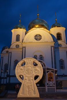 Christian Church against the evening sky lit by the rays of searchlights in the city of Krasnodar
