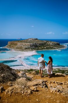 Crete Greece, Balos lagoon on Crete island, Greece. Tourists relax and bath in crystal clear water of Balos beach. Greece, couple men and woman visiting the beach