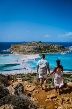 Crete Greece, Balos lagoon on Crete island, Greece. Tourists relax and bath in crystal clear water of Balos beach. Greece, couple men and woman visiting the beach