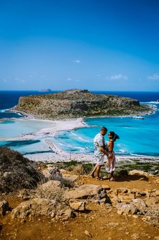 Crete Greece, Balos lagoon on Crete island, Greece. Tourists relax and bath in crystal clear water of Balos beach. Greece, couple men and woman visiting the beach