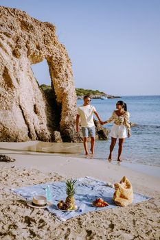 Tropical beach of Voulisma beach, Istron, Crete, Greece Europe, couple men and woman mid age on the beach during vacation in the summer of Europe