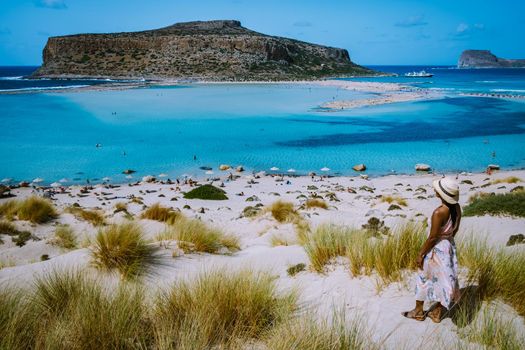 Crete Greece, Balos lagoon on Crete island, Greece. Tourists relax and bath in crystal clear water of Balos beach. Greece