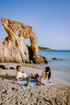 Tropical beach of Voulisma beach, Istron, Crete, Greece Europe, couple men and woman mid age on the beach during vacation in the summer of Europe