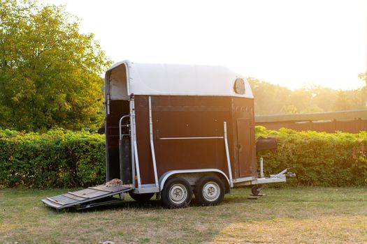 Horse trailer standing outdoor with open door. vehicle for horse transportation Travel with animals