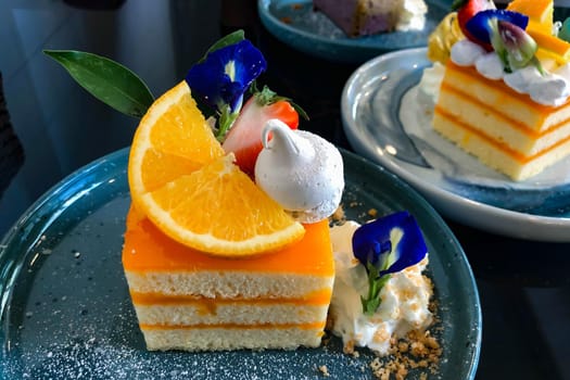 Orange cake with orange topping on plate ready to eat