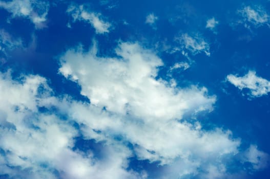 Blue sky with thick clouds outdoors in the summer.Texture or background