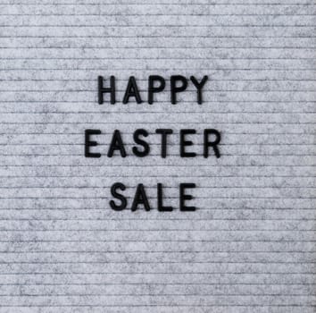 Easter holiday concept. The words Happy Easter Sale on the grey felt letter board