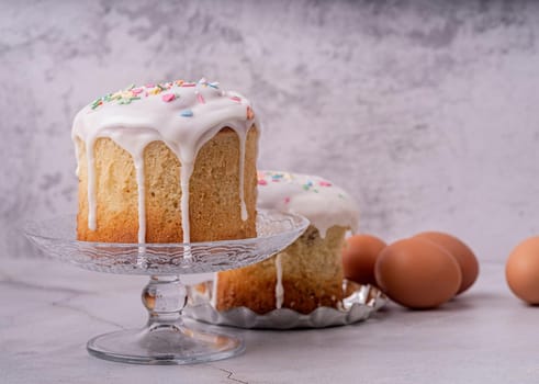 Easter holiday concept. Easter Cake with eggs on white marble background front view with copy space