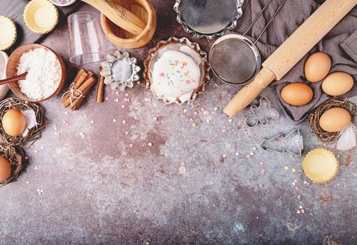 Baking concept. Easter concept. Ingredients for an Easter cake flat lay top view on dark background