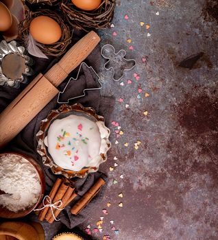 Baking concept. Easter concept. Ingredients for an Easter cake flat lay top view on dark background