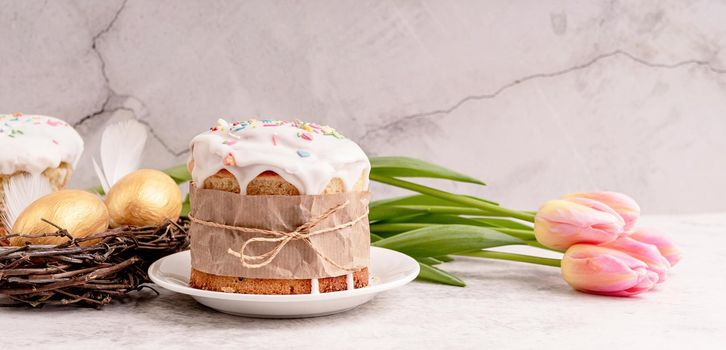 Easter concept. Glazed Easter cake with tulips and colored eggs front view