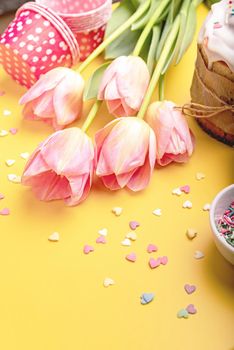 Easter holiday creative background with easter cake, tulips and decorations top view flat lay with copy space