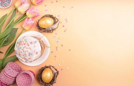 Easter holiday creative background with easter cake, eggs in nests, tulips and decorations top view flat lay with copy space