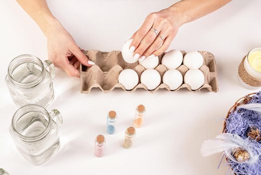 Easter concept. Woman hands holding eggs redy for coloring
