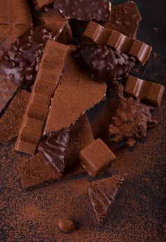 dark chocolate over wooden background, selective focus.