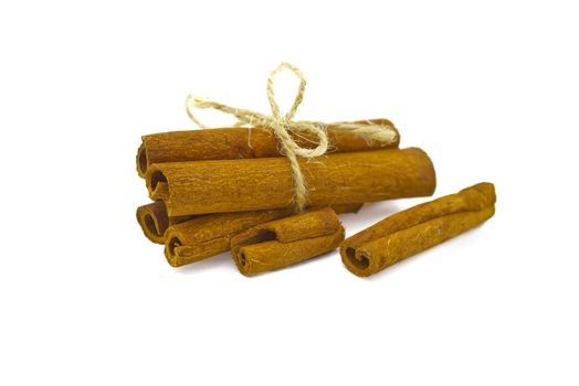 Cinnamon sticks bundle tied with jute string isolated on white background