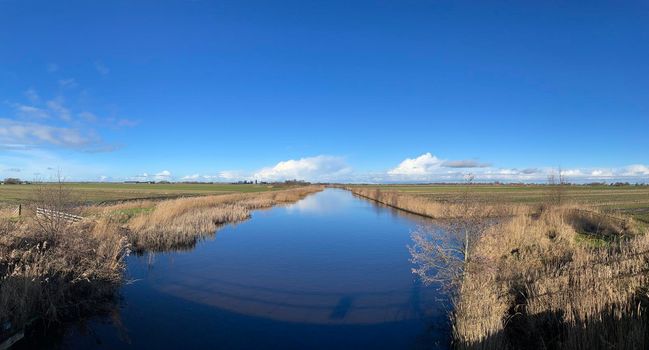 Panorama from a canal on a winter day around Broek in Friesland The Netherlands