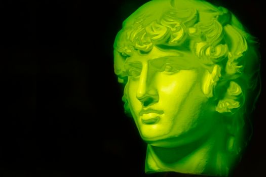 A statue. Plaster decorative neon statue of Apollo head.