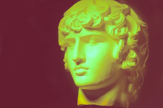 Blurred plaster decorative statue of Apollo's head in vintage color.