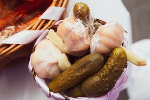 Pickled cucumbers and garlic on a plate. Canned vegetables.