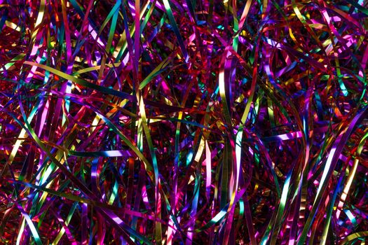 Festive background. Lots of multicolored tinsel close-up.