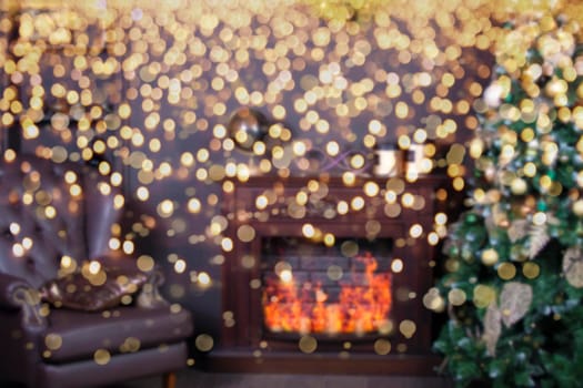 Blurred Christmas interior with fir tree and fireplace against bright golden bokeh.