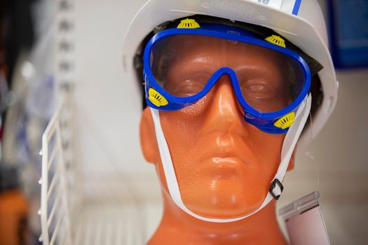 Close-up of the face of a plastic mannequin wearing goggles.