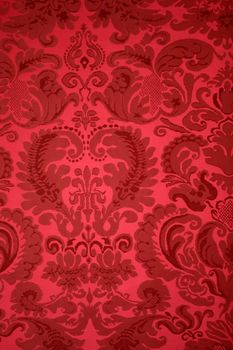 An old pattern on tapestry fabric.Vintage retro background red.