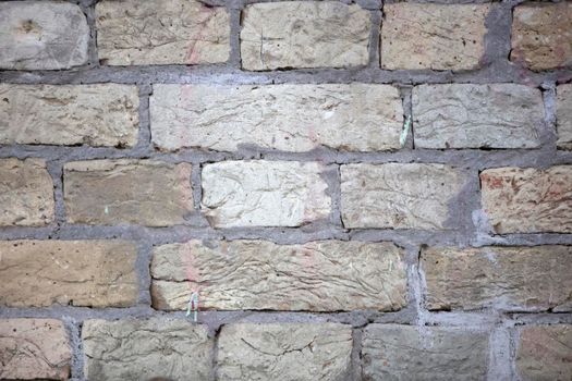 Brick wall. Uneven brick texture close up.