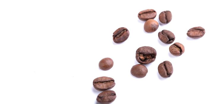 Scattered coffee beans on a white background. Arabica or robusta.