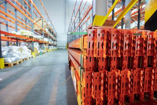 Warehouse premises of a factory or workshop with metal shelves.