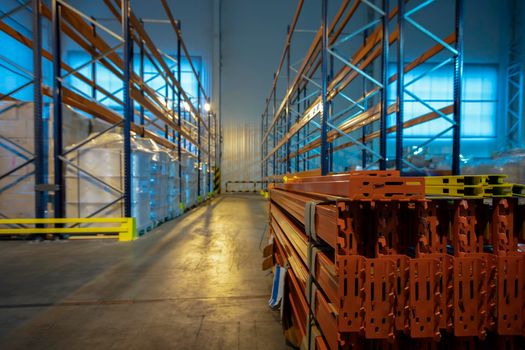 Warehouse premises of a factory or workshop with metal shelves.