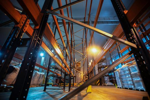 Warehouse premises of a factory or workshop with metal shelves.