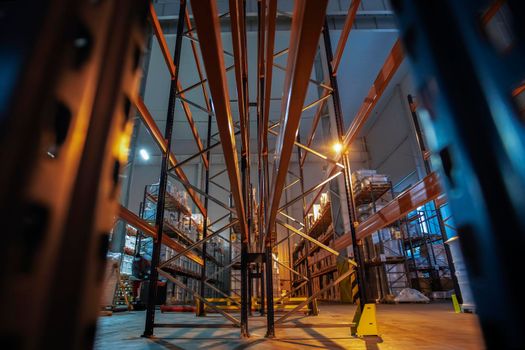 Warehouse premises of a factory or workshop with metal shelves.