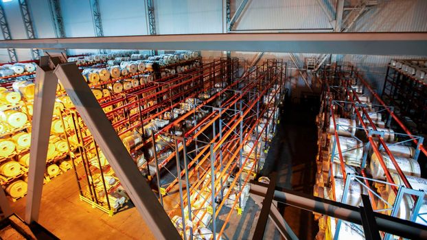 Warehouse premises of a factory or workshop with metal shelves.