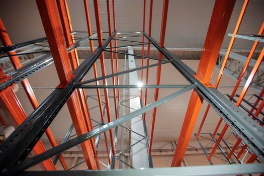Warehouse premises of a factory or workshop with metal shelves.