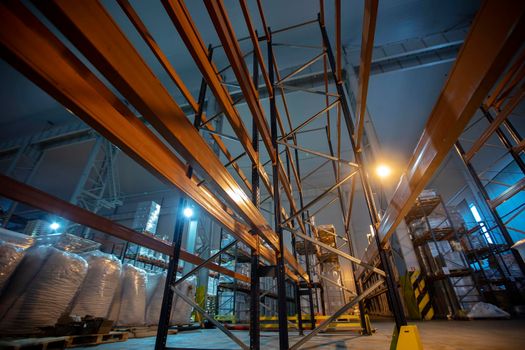 Warehouse premises of a factory or workshop with metal shelves.
