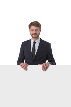 Young man in suit showing banner whiteboard sign isolated on white background