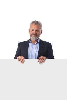 Mature man in suit showing banner whiteboard sign isolated on white background